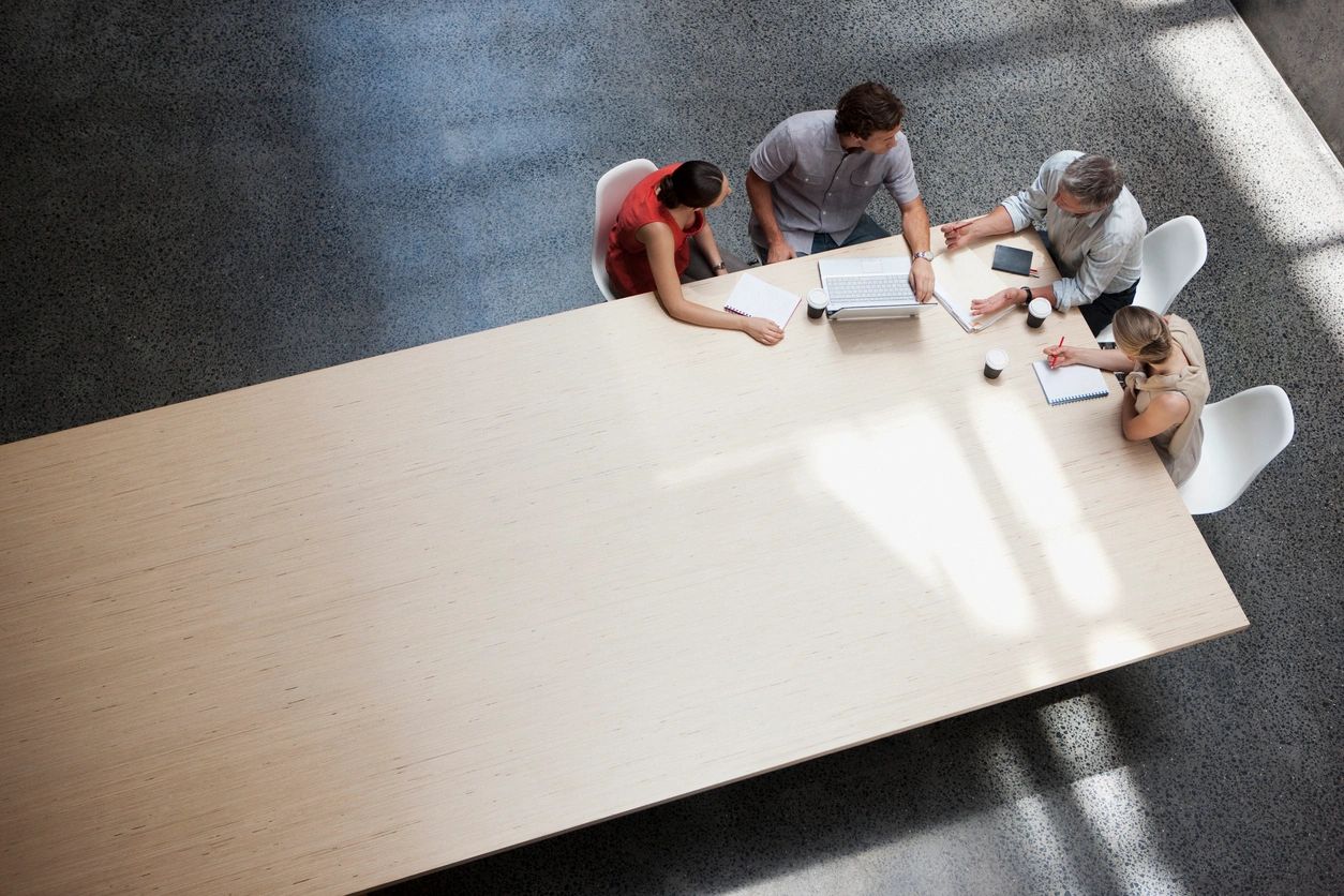 Overhead view of four people meeting