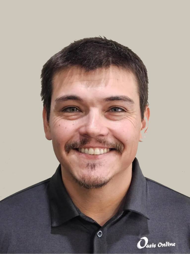 Smiling young man headshot in dark polo