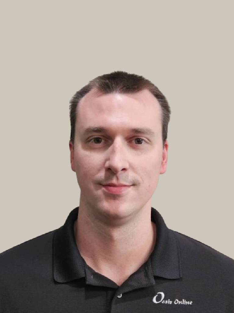 Headshot of person in black polo, neutral background