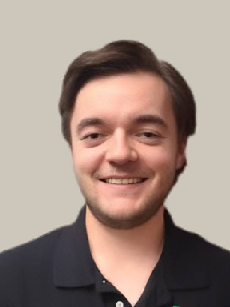 Smiling young man against neutral background