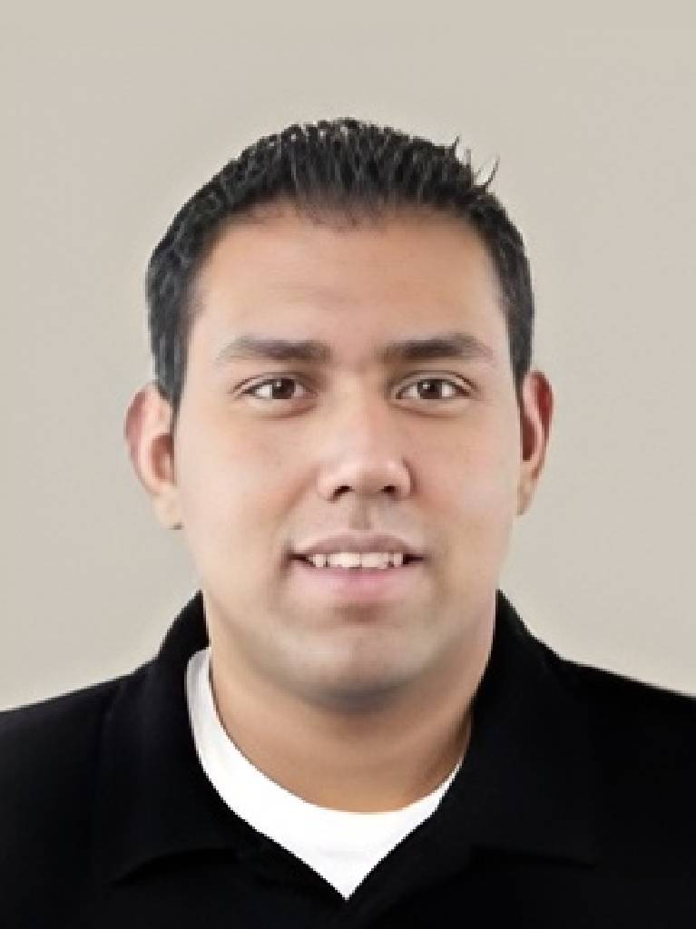 Professional headshot of smiling young man